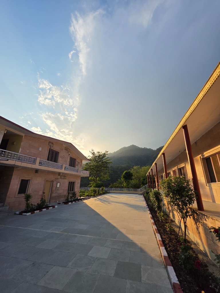 Paved courtyard path of the ashram facing the hills